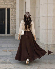 Beautiful printed corset with beige shirt % brown skirt